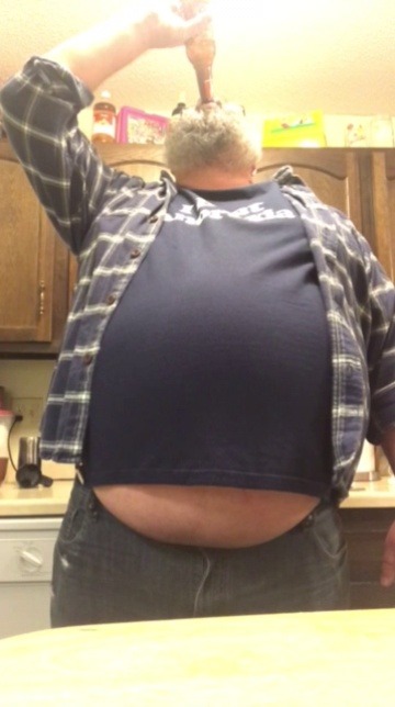 Round belly. Beer belly man in Shirt